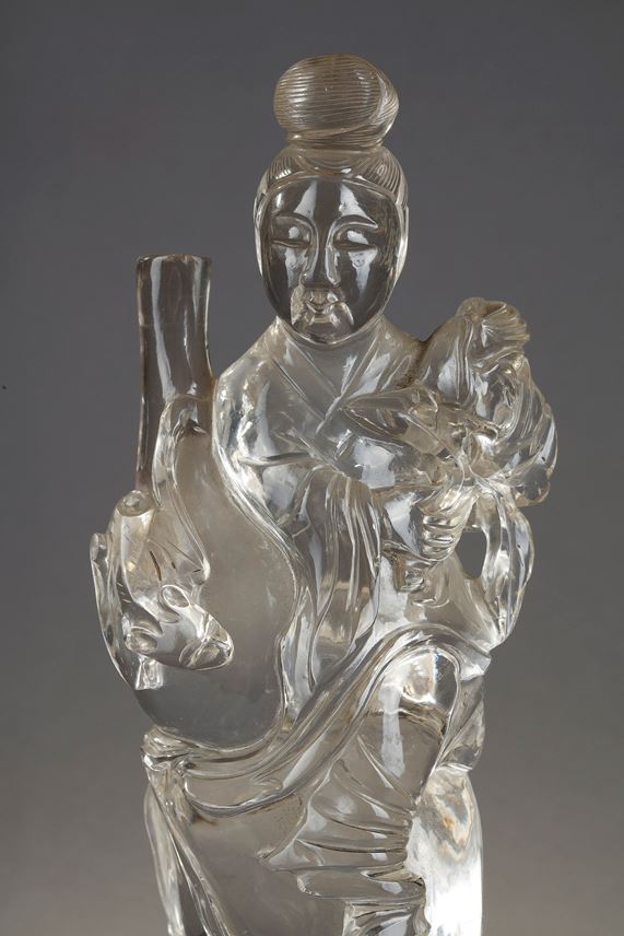 Rock crystal figure representing a guanyin holding a vase and a flower. Wooden base | MasterArt